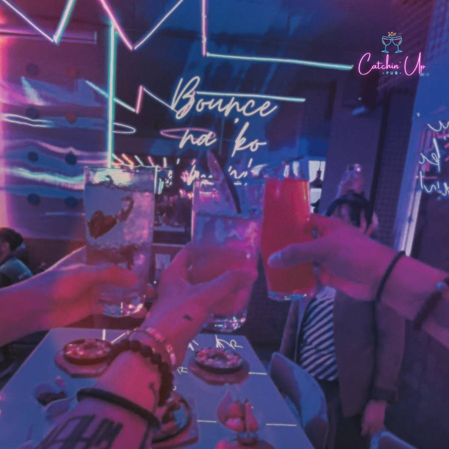 Friends raising glasses at Catchin' Up Jupiter Street